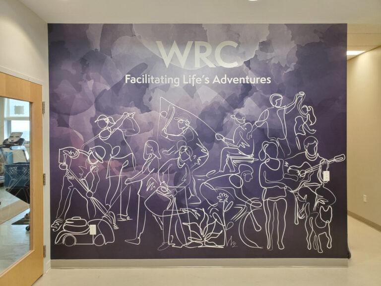 Wall mural in the Woodstock Rehabilitation Clinic featuring line art illustrations and the text "WRC Facilitating Life's Adventures"